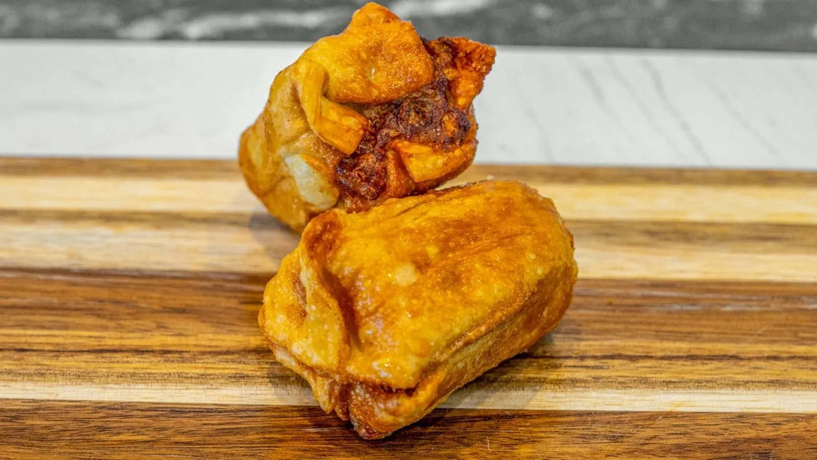 Battered potato scallops on a serving board