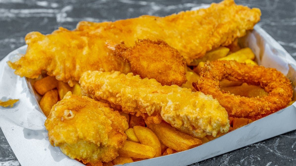 Golden battered fish and chips spread, freshly cooked at On the Hook